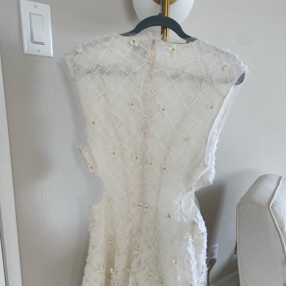 Stunning ivory white open cutting out with delicate flowers cute detailing. - Picture 3 of 16